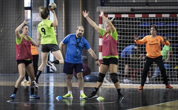 El entrenador Juanjo González dirige un entrenamiento mientras Valentina Learreta lanza a portería. / JUSTO RODRÍGUEZ