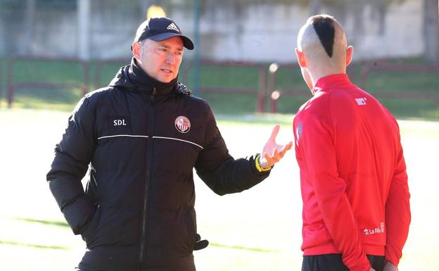 Raúl Llona charla con Jon Madrazo, que sigue lesionado y no estará este domingo ante la Real Sociedad B. /Juan Marín