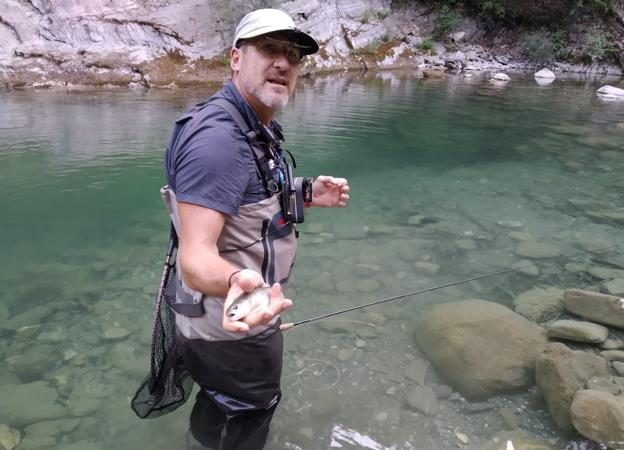 Herce muestra una trucha en Ansó antes de devolverla al agua. / L. R.